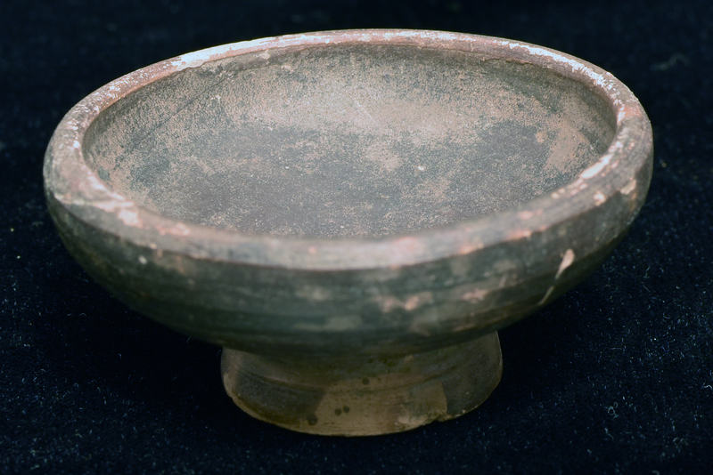 Bowl w convex sides spreading to incurving rim w plain edge; fairly high ring base, conical on underside w central nipple. Coated over int and ext, except for part of base edge, w paint spreading onto part of underside of base.