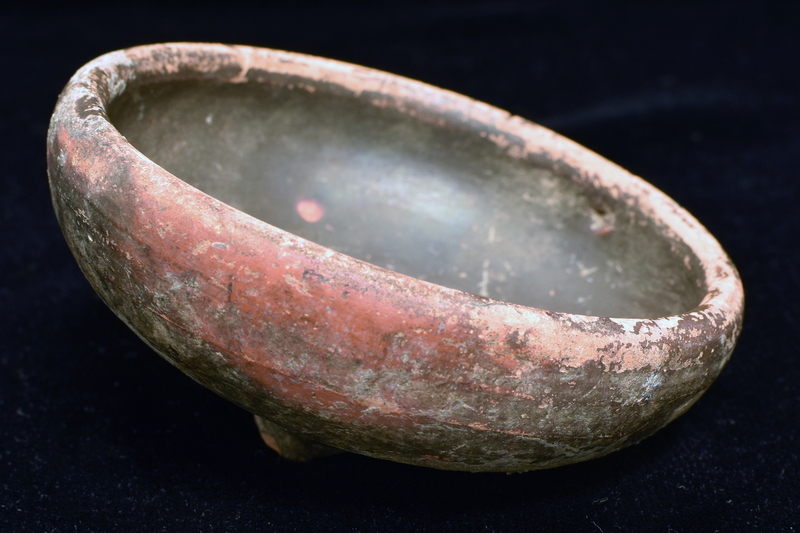 Bowl w spreading convex walls curving in to plain thick edge; foot not pres.  Coated all over w dark paint.