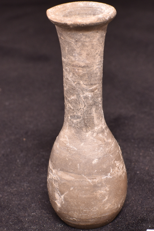 Piriform body with tall cylindrical neck flaring slightly to outturned rim; sharply defined flat base with clear marks in center where separated from wheel.  Neck and interior of rim painted.