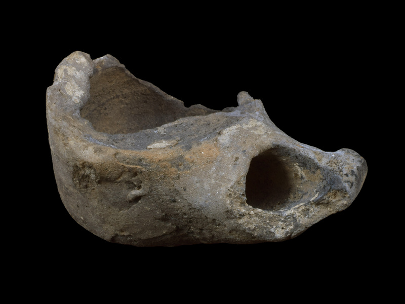 Tall, straight-sided reservoir w short bevel to ca. flat base; traces of small, un-pierced lug on edge of body wall and top surface which, as pres., plain & concave; broad, spathate nozzle.  No evidence of paint.
