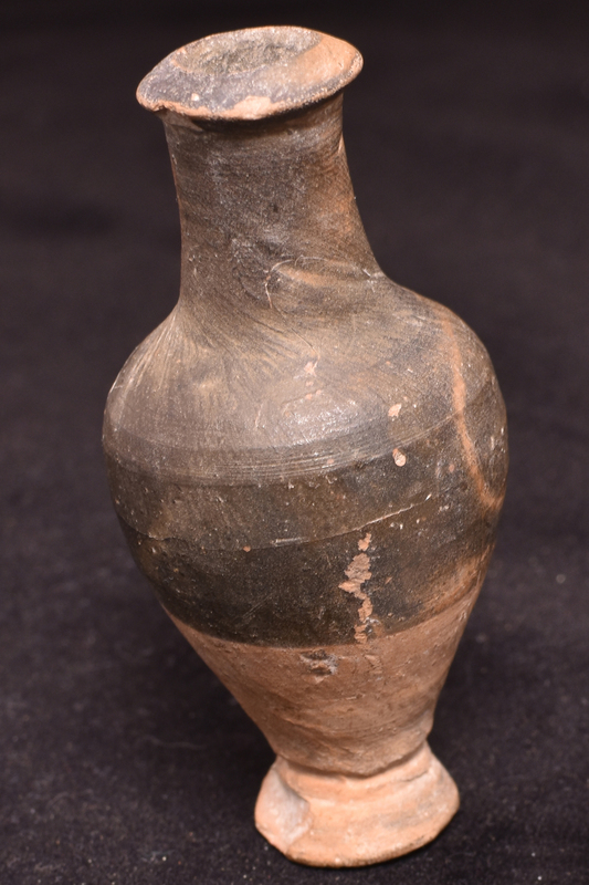 Body with high maximum diameter on flaring pedestal foot; fairly short cylindrical neck with thick flared rim.  Dark metallic paint applied from just below mid-height to interior of rim.
