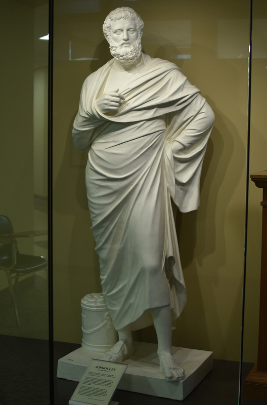 Cast of an original in the Vatican Museums, Rome. The marble statue is a Roman copy of a Greek bronze original of the late 4th century BCE, probably from the circle of the sculptor Leochares; the original statue may have been set up in the theater of Dionysos in Athens by Lycurgos, the leader of Athens, in the 340s BCE.

Sophocles was one of the foremost writers of Greek tragedies in the 5th century BCE, author of more than 120 plays -- only 7 have survived: Oedipus the King, Antigone, Ajax, Electra, Trachiniae, Philoctetes, and Oedipus at Colonos. Here he is shown with a circlet in his hair, an honor granted him after his death allowing his worship as the Heros Dexion who introduced the cult of the healing god Asklepios into Athens. At the feet of the poet is a round container holding eight scrolls.