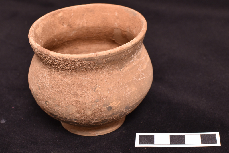 Bowl w bulbous max d on low ring base w tall outturned rim.  Lower body and base ext & underside of edge coated w dark paint; on upper body & ext of rim faded stripes of varying thickness.