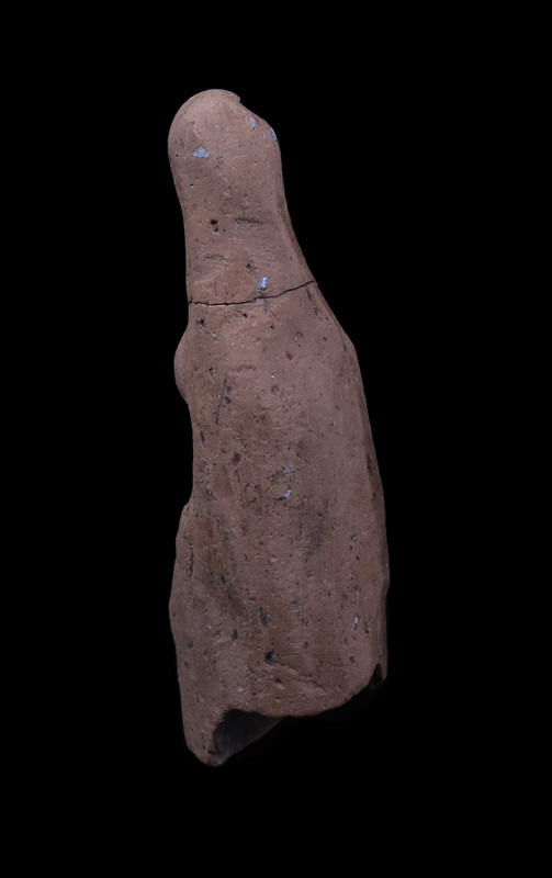 Mouldmade elongated figure wearing palla pulled over head and falling at sides, pulled across body over right arm which is bent up across body; probably held in left hand which rests just below right.  Stola, pulled tight under breast, falls in vertical pleats from waist.