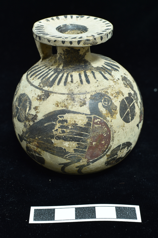 Round -bodied aryballos decorated with procession of 3 geese with decoration incised  and in added red ;  in field blob rosettes with cruciform incisions; base and shoulder decorated with radiating stripes separated from body by narrow horizontal stripe; edge and outer surface of rim decorated with radiating stripes; single stripe around mouth, 2 concentric stripes around solidly coated depression in base; 3 h stripes on back of handle.